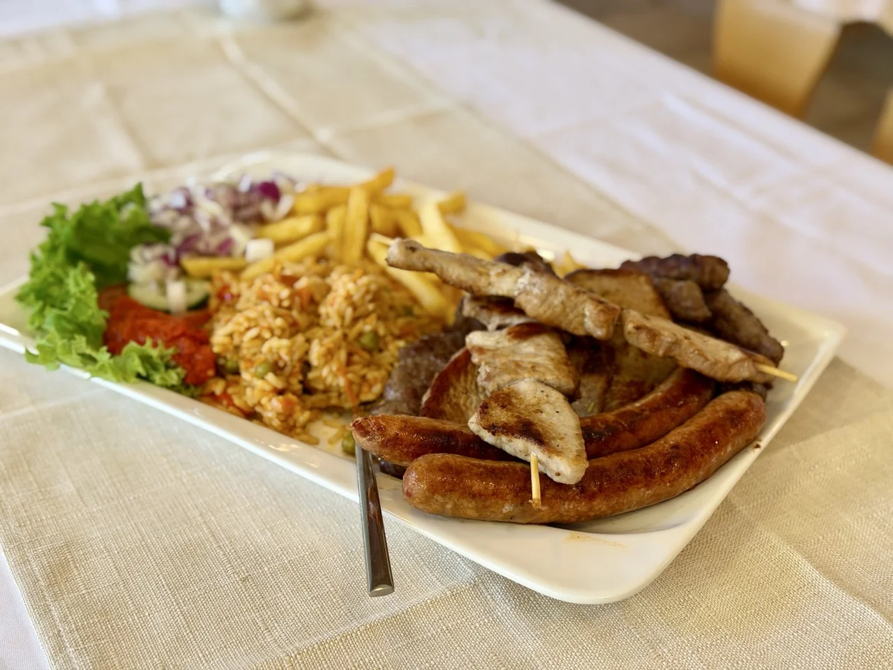 Grillplatte mit Reis, Pommes und Ćevapčići